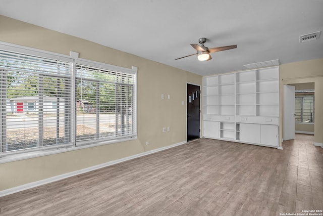 unfurnished living room featuring light hardwood / wood-style flooring and ceiling fan