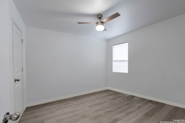 spare room with light wood-type flooring and ceiling fan