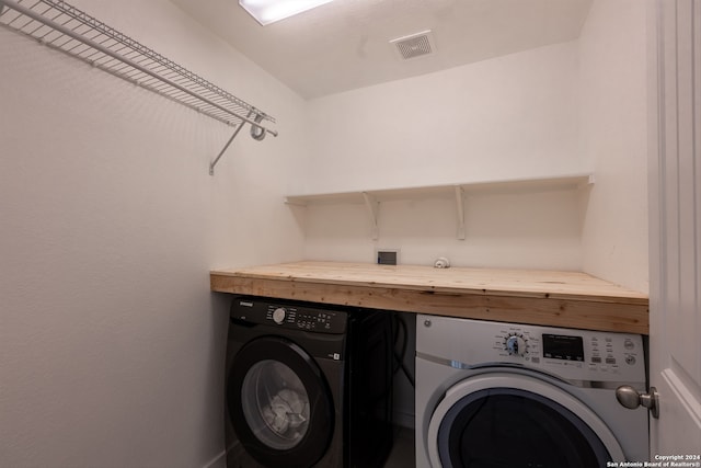 washroom with washing machine and clothes dryer