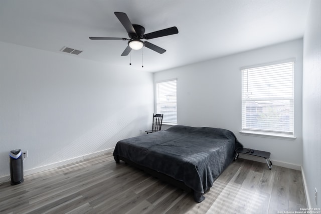 bedroom with ceiling fan and wood-type flooring