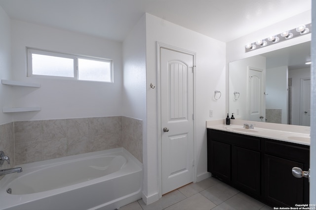 bathroom with vanity, a tub to relax in, and tile patterned flooring