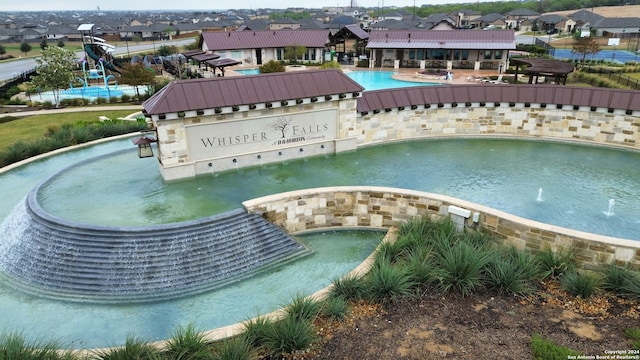 view of swimming pool featuring pool water feature