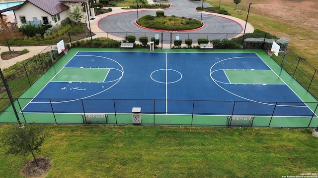 view of sport court featuring a lawn