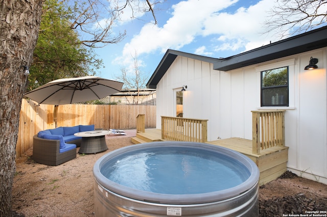 view of pool featuring an outdoor fire pit and a deck