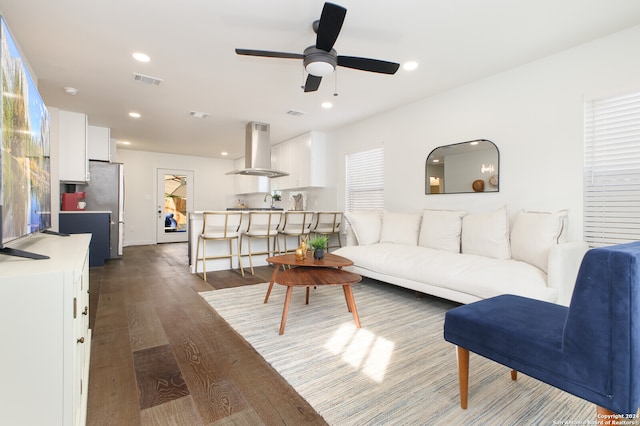 living room featuring dark hardwood / wood-style floors and ceiling fan