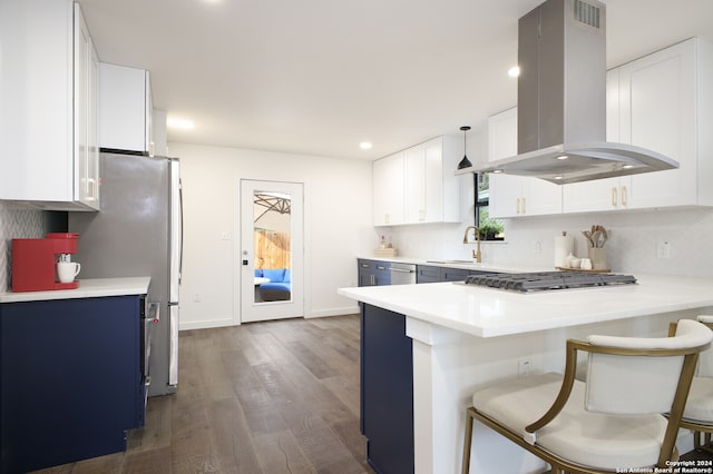 kitchen featuring sink, island exhaust hood, white cabinets, a breakfast bar area, and dark hardwood / wood-style floors