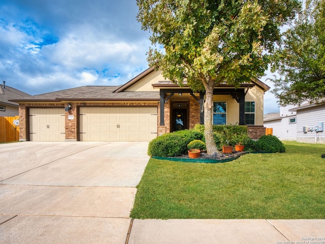 view of front of home with a front yard and a garage