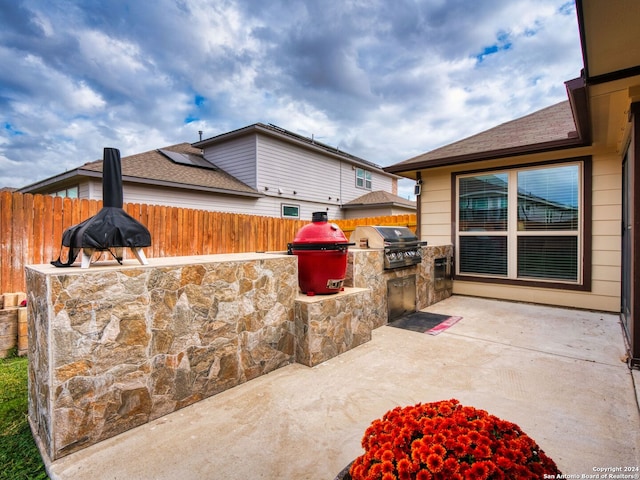 view of patio / terrace with exterior kitchen and a grill