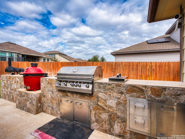 view of patio with grilling area and an outdoor kitchen