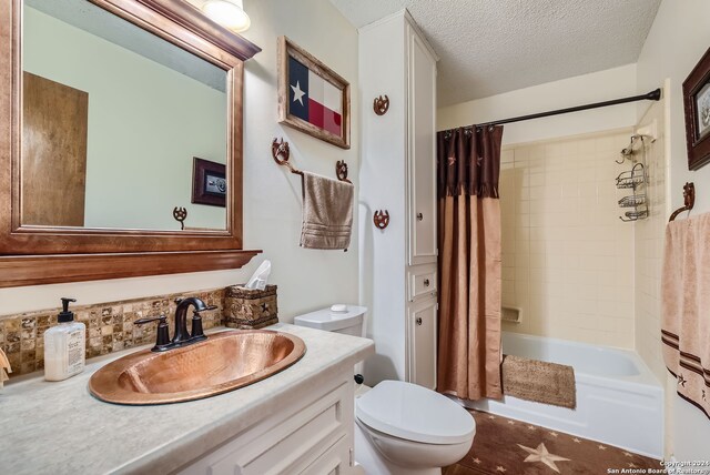 full bathroom with shower / bath combination with curtain, backsplash, a textured ceiling, toilet, and vanity