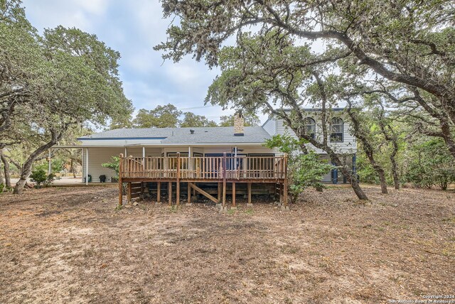 back of house featuring a wooden deck