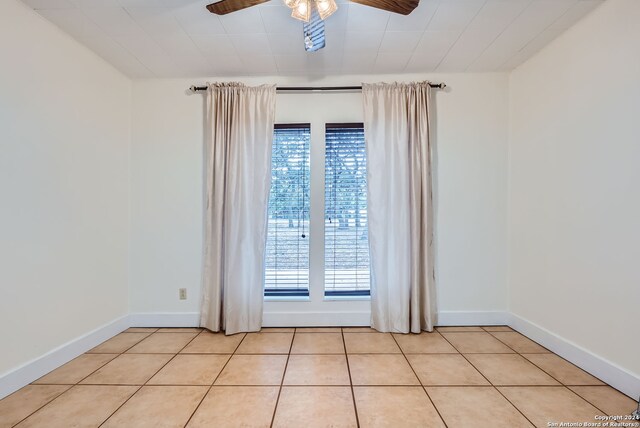 spare room with light tile patterned floors and ceiling fan