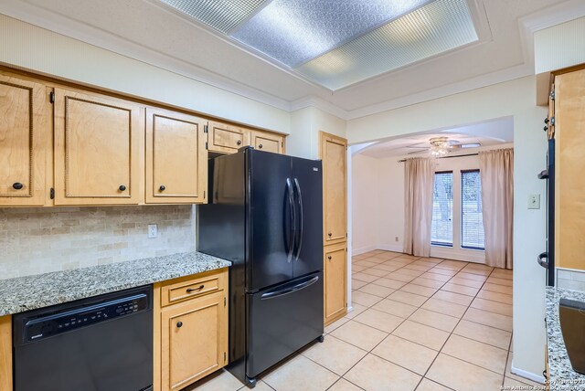 kitchen featuring light stone countertops, tasteful backsplash, black appliances, and light tile patterned floors