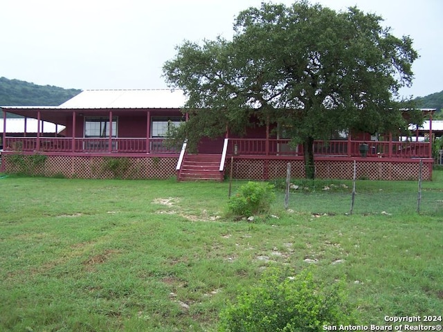 view of yard with a deck with mountain view