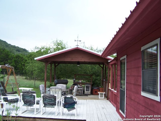 wooden terrace featuring a gazebo