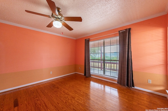 empty room with ceiling fan, hardwood / wood-style floors, crown molding, and a textured ceiling