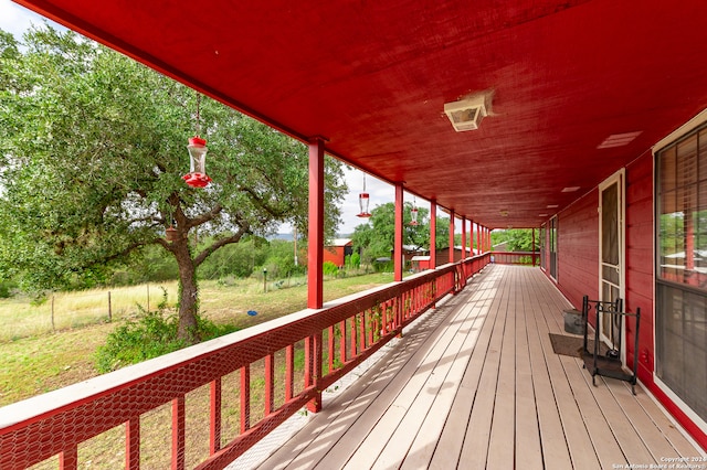 wooden terrace with a porch