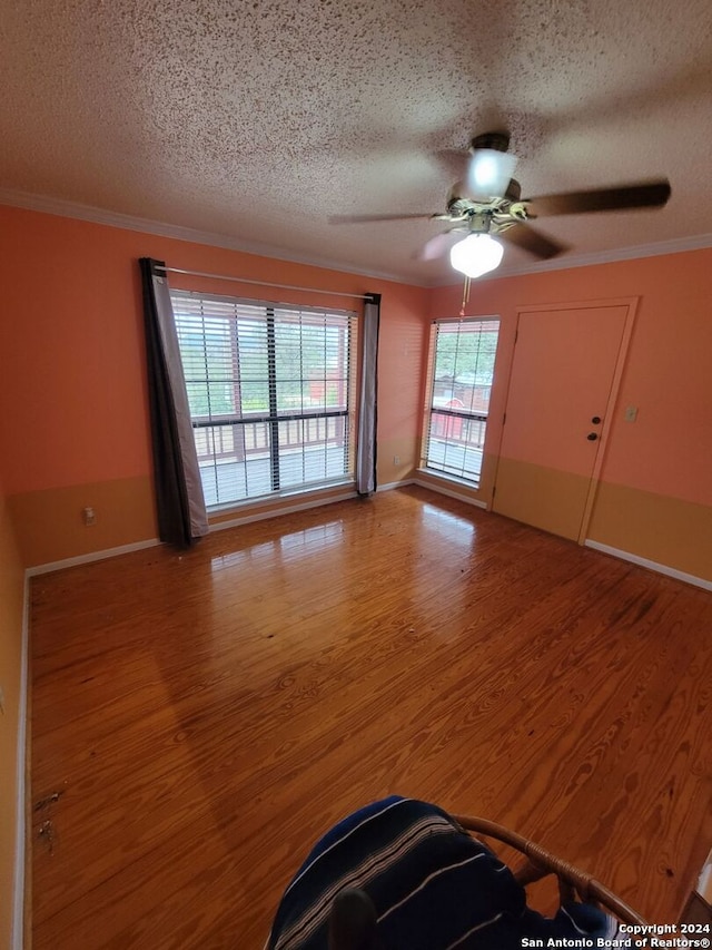 unfurnished room featuring hardwood / wood-style floors and a textured ceiling