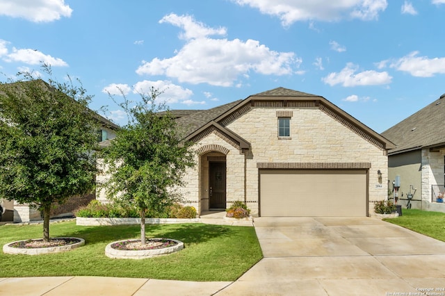 view of front of property with a front yard and a garage