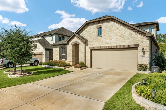 view of front facade with a garage and a front lawn