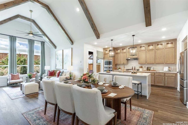 dining room featuring beam ceiling, dark hardwood / wood-style floors, and ceiling fan