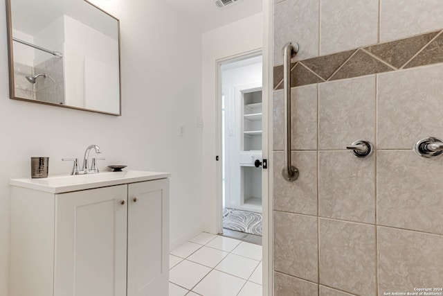 bathroom featuring vanity, tiled shower, and tile patterned floors