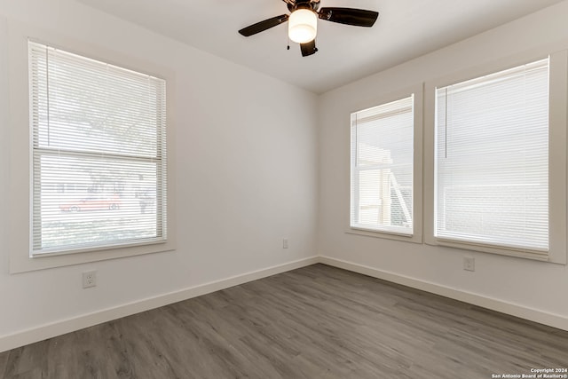 unfurnished room with dark wood-type flooring and ceiling fan