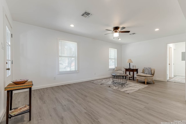 living area featuring light hardwood / wood-style flooring and ceiling fan