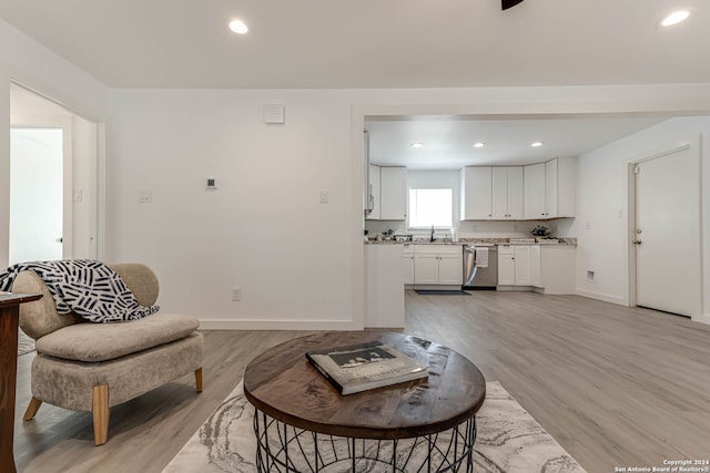 living room with sink and light hardwood / wood-style flooring