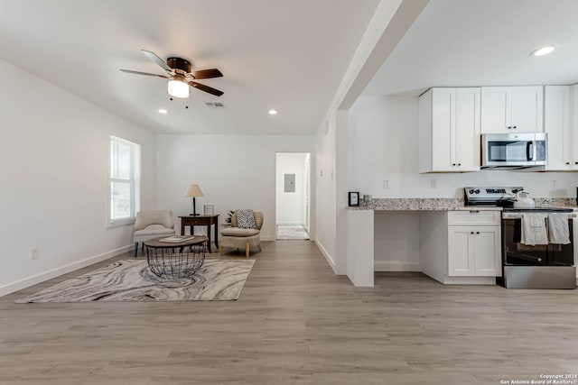 kitchen featuring light stone countertops, appliances with stainless steel finishes, ceiling fan, white cabinets, and light hardwood / wood-style flooring