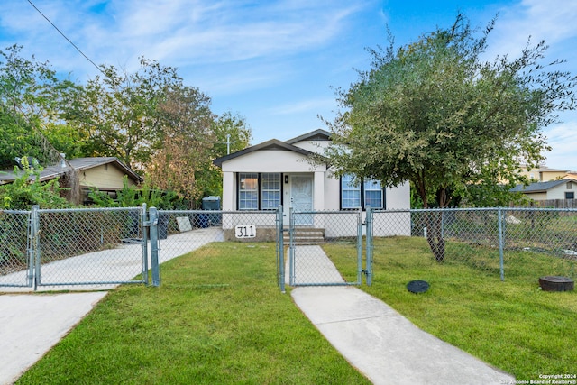 bungalow-style house with a front lawn