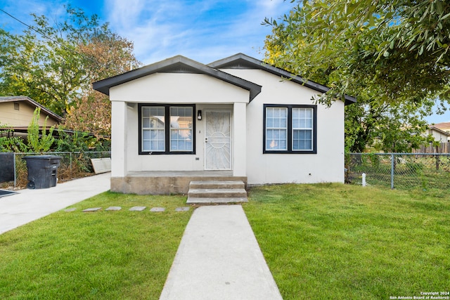 bungalow-style house featuring a front yard