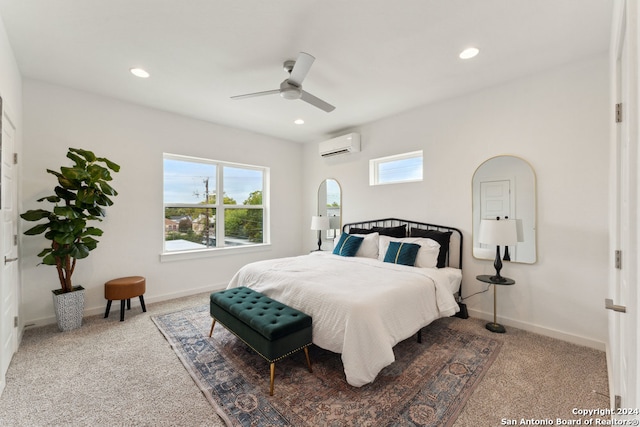 carpeted bedroom featuring a wall mounted air conditioner and ceiling fan