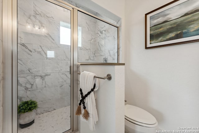 bathroom featuring toilet and an enclosed shower