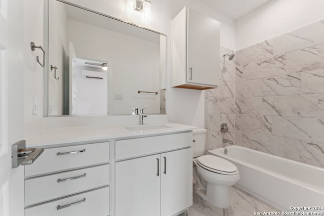 full bathroom featuring vanity, tiled shower / bath combo, and toilet