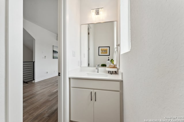 bathroom with vanity and hardwood / wood-style floors