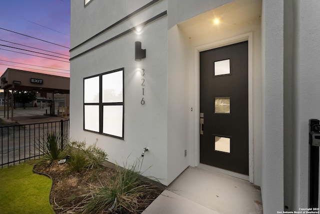 3216 N Elmendorf St, San Antonio, TX 78201 - exterior entry at dusk featuring stucco siding