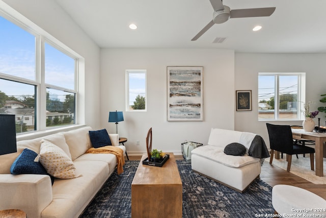 living room featuring dark wood-type flooring and ceiling fan