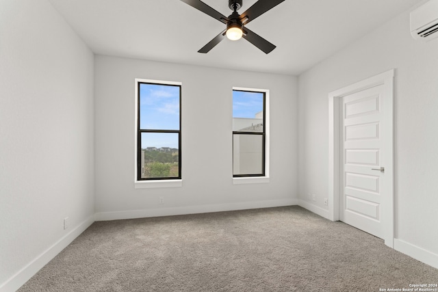 carpeted spare room featuring ceiling fan and a wall mounted AC