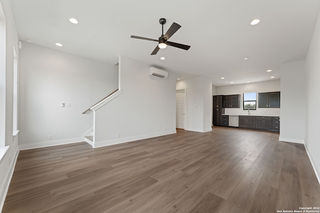 unfurnished living room featuring dark wood-type flooring, ceiling fan, and a wall mounted air conditioner