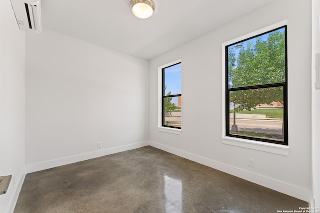 unfurnished room with a wall mounted AC