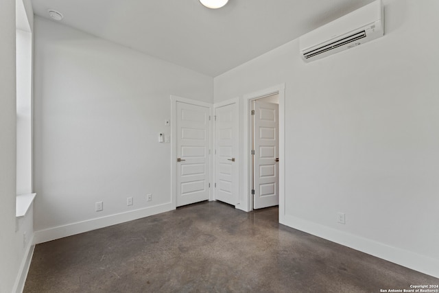 unfurnished bedroom featuring an AC wall unit