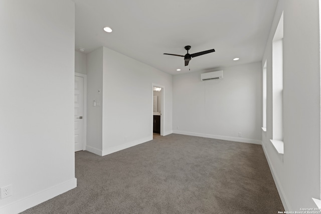 spare room with ceiling fan, carpet, and a wall unit AC