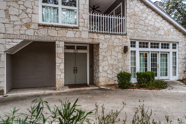 doorway to property with a balcony and a garage