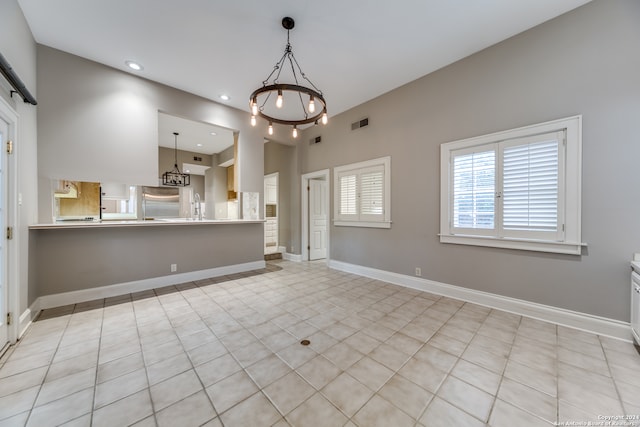 interior space with an inviting chandelier and light tile patterned floors