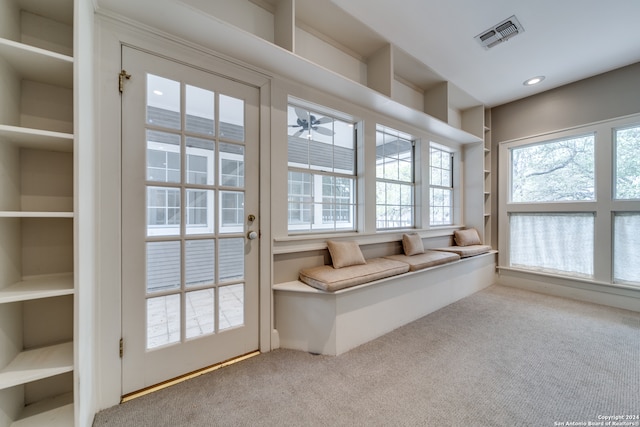 interior space with carpet flooring and ceiling fan