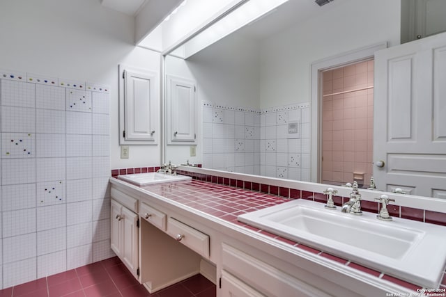 bathroom with tile walls, vanity, and tile patterned floors