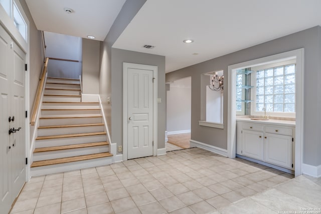 tiled entryway featuring sink