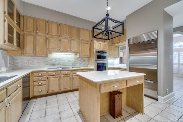 kitchen with black appliances, a center island, a chandelier, and light tile patterned floors