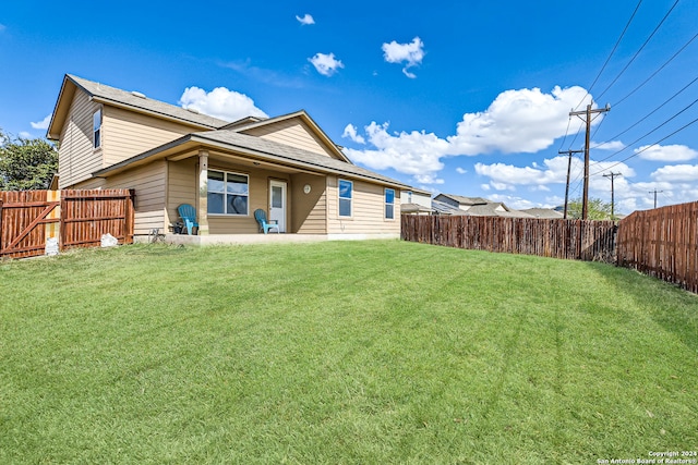 rear view of house with a lawn